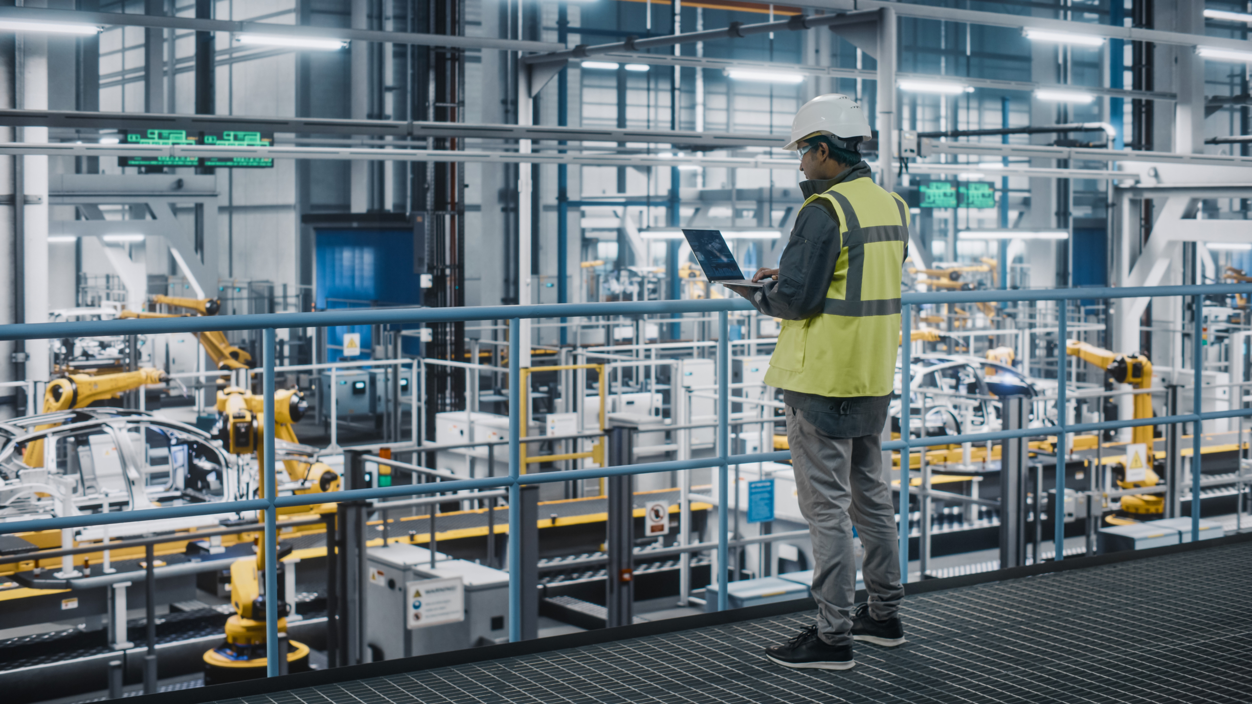 EHS Single Worker Looking At Laptop In Factory